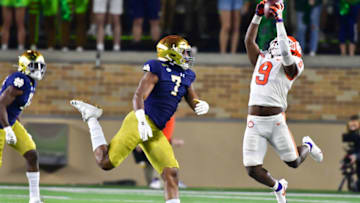 Nov 7, 2020; South Bend, Indiana, USA; Clemson Tigers running back Travis Etienne (9) catches a pass as Notre Dame Fighting Irish defensive lineman Isaiah Foskey (7) defends in the third quarter at Notre Dame Stadium. Mandatory Credit: Matt Cashore-USA TODAY Sports