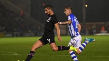 COLCHESTER, ENGLAND - AUGUST 09: Conor Hourihane of Aston Villa shoots at goal as he is challenged by James Bree of Colchester during the Carabao Cup First Round match between Colchester United and Aston Villa at Colchester Community Stadium on August 9, 2017 in Colchester, England. (Photo by Mike Hewitt/Getty Images)