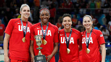 TENERIFE, SPAIN - SEPTEMBER 30: Elena Delle Donne #11 Nnemkadi Ogwumike #13 Layshia Clarendon #7 and Sue Bird #6 of the USA National Team look on with the Championship trophy after defeating the Australia team during the Gold Medal Game of the FIBA Women's Basketball World Cup at Pabellon de Deportes de Tenerife Santiago Martin on September 30, 2018 in San Cristobal de La Laguna, Spain. NOTE TO USER: User expressly acknowledges and agrees that, by downloading and or using this photograph, User is consenting to the terms and conditions of the Getty Images License Agreement. Mandatory Copyright Notice: Copyright 2018 NBAE. (Photo by Catherine Steenkeste/NBAE via Getty Images)