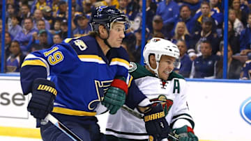 Oct 13, 2016; St. Louis, MO, USA; St. Louis Blues defenseman Jay Bouwmeester (19) and Minnesota Wild left wing Zach Parise (11) battle for position during the first period at Scottrade Center. Mandatory Credit: Billy Hurst-USA TODAY Sports