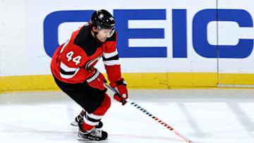 NEWARK, NEW JERSEY - JANUARY 16: Miles Wood #44 of the New Jersey Devils takes the puck in the overtime period against the Boston Bruins at Prudential Center on January 16, 2021 in Newark, New Jersey. Due to Covid-19 restrictions, the game is played without fans. The New Jersey Devils defeated the Boston Bruins 2-1 in overtime. (Photo by Elsa/Getty Images)
