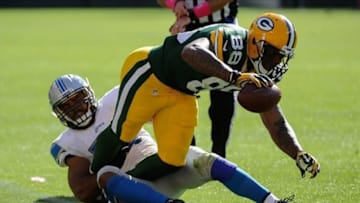 Oct 6, 2013; Green Bay, WI, USA; Green Bay Packers tight end Jermichael Finley (88) runs with the ball as Detroit Lions linebacker DeAndre Levy (54) defends in the fourth quarter at Lambeau Field. Mandatory Credit: Benny Sieu-USA TODAY Sports
