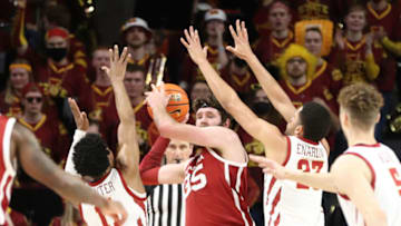 Feb 19, 2022; Ames, Iowa, USA; Oklahoma Sooners forward Tanner Groves (35) is defended by Iowa State Cyclones guard Tyrese Hunter (11) and guard Tristan Enaruna (23) at James H. Hilton Coliseum. The Cyclones win 75 to 54. Mandatory Credit: Reese Strickland-USA TODAY Sports
