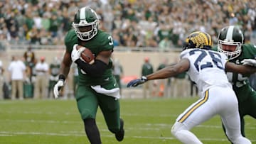 Oct 29, 2016; East Lansing, MI, USA; Michigan State Spartans running back LJ Scott (3) scores a touchdown against the Michigan Wolverines during the first half at Spartan Stadium. Mandatory Credit: Brad Mills-USA TODAY Sports