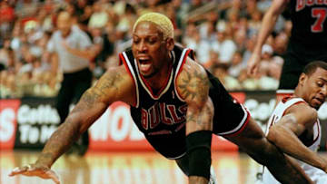 PHILADELPHIA, : The Chicago Bulls Dennis Rodman dives for the loose ball during their game against the Philadelphia 76ers 17 April in Philadelphia. The Bulls won 87-80, increasing their record to 61-20. AFP PHOTO/TOM MIHALEK (Photo credit should read TOM MIHALEK/AFP via Getty Images)