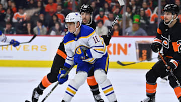 Mar 17, 2023; Philadelphia, Pennsylvania, USA; Buffalo Sabres defenseman Henri Jokiharju (10) fights for position with Philadelphia Flyers center Tanner Laczynski (58) in the third period at Wells Fargo Center. Mandatory Credit: Kyle Ross-USA TODAY Sports