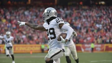 Jan 3, 2016; Kansas City, MO, USA; Oakland Raiders cornerback David Amerson (29) intercepts a pass and runs in for a touchdown during the first half against the Kansas City Chiefs at Arrowhead Stadium. Mandatory Credit: Denny Medley-USA TODAY Sports