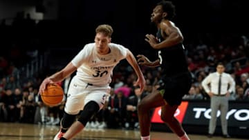 Cincinnati Bearcats forward Viktor Lakhin drives against Cleveland State Vikings. The Enquirer.