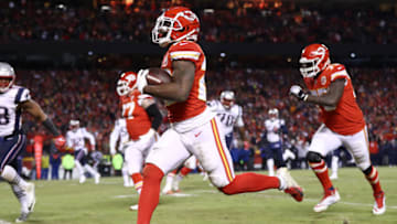KANSAS CITY, MISSOURI - JANUARY 20: Damien Williams #26 of the Kansas City Chiefs runs with the ball on his way to scoring a 23-yard receiving touchdown in the fourth quarter against the New England Patriots during the AFC Championship Game at Arrowhead Stadium on January 20, 2019 in Kansas City, Missouri. (Photo by Jamie Squire/Getty Images)