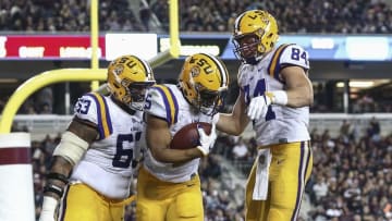 Nov 24, 2016; College Station, TX, USA; LSU Tigers running back Derrius Guice (5) celebrates with guard K.J. Malone (63) and tight end Foster Moreau (84) after scoring a touchdown during the third quarter against the Texas A&M Aggies at Kyle Field. Mandatory Credit: Troy Taormina-USA TODAY Sports