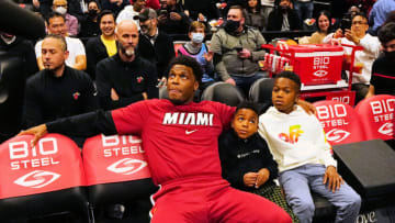 Miami Heat guard Kyle Lowry (7) sits with his boys on the bench before the start of the game against the Toronto Raptors at Scotiabank Arena.(John E. Sokolowski-USA TODAY Sports)