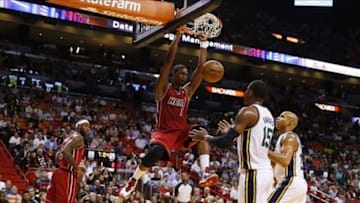 Dec 16, 2013; Miami, FL, USA; Miami Heat center Chris Bosh (1) dunks the ball as Utah Jazz power forward Derrick Favors (15) and small forward Richard Jefferson (24) look on in the first half at American Airlines Arena. Mandatory Credit: Robert Mayer-USA TODAY Sports