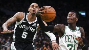 BOSTON, MA - JANUARY 05: Dennis Schroder #71 of the Boston Celtics drives to the basket past Dejounte Murray #5 of the San Antonio Spurs during a game at TD Garden on January 5, 2022 in Boston, Massachusetts. NOTE TO USER: User expressly acknowledges and agrees that, by downloading and or using this photograph, User is consenting to the terms and conditions of the Getty Images License Agreement. (Photo by Adam Glanzman/Getty Images)
