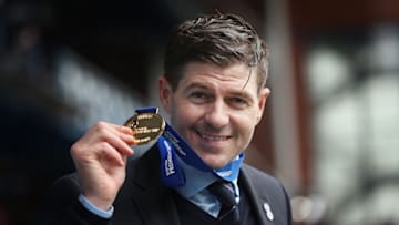 GLASGOW, SCOTLAND - MAY 15: Rangers Manager Steven Gerrard poses with his medal during the Scottish Premiership match between Rangers and Aberdeen on May 15, 2021 in Glasgow, Scotland. Sporting stadiums around the UK remain under strict restrictions due to the Coronavirus Pandemic as Government social distancing laws prohibit fans inside venues resulting in games being played behind closed doors. (Photo by Ian MacNicol/Getty Images)