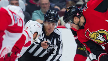 OTTAWA, ON - OCTOBER 07: Linesmen Tony Sericolo (84) prepares to drop the puck at a face-off contested between Detroit Red Wings Center Frans Nielsen (51) and Ottawa Senators Right Wing Bobby Ryan (9) during the NHL game between the Ottawa Senators and the Detroit Red Wings on Oct. 7, 2017 at the Canadian Tire Centre in Ottawa, Ontario, Canada. (Photo by Steven Kingsman/Icon Sportswire via Getty Images)