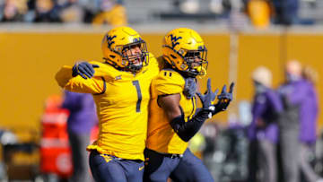 Oct 31, 2020; Morgantown, West Virginia, USA; West Virginia Mountaineers cornerback Nicktroy Fortune (11) celebrates with linebacker Tony Fields II (1) after an interception during the first quarter against the Kansas State Wildcats at Mountaineer Field at Milan Puskar Stadium. Mandatory Credit: Ben Queen-USA TODAY Sports