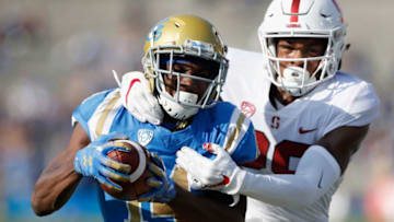 PASADENA, CA - NOVEMBER 24: Theo Howard #14 of the UCLA Bruins eludes the defense of Kendall Williamson #29 of the Stanford Cardinal on a pass play during the first half of a game at the Rose Bowl on November 24, 2018 in Pasadena, California. (Photo by Sean M. Haffey/Getty Images)