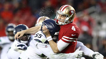 SANTA CLARA, CA - DECEMBER 16: Nick Mullens #4 of the San Francisco 49ers is hit by Frank Clark #55 of the Seattle Seahawks during their NFL game at Levi's Stadium on December 16, 2018 in Santa Clara, California. (Photo by Ezra Shaw/Getty Images)