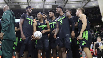 EAST LANSING, MI - JANUARY 17: Cassius Winston #5 of the Michigan State Spartans celebrates with his teammates after receiving a commemorative ball from Former Spartan Mateen Cleaves for breaking his Big Ten assist record after the game against the Wisconsin Badgers at the Breslin Center on January 17, 2020 in East Lansing, Michigan. (Photo by Rey Del Rio/Getty Images)