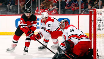 NEWARK, NJ - FEBRUARY 10: Petr Mrazek #34 of the Carolina Hurricanes makes a save as Kyle Palmieri #21 of the New Jersey Devils looks for the rebound during the game at Prudential Center on February 10, 2019 in Newark, New Jersey. (Photo by Adam Hunger/Getty Images)