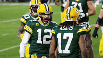GREEN BAY, WISCONSIN - JANUARY 16: Aaron Rodgers #12 of the Green Bay Packers celebrates throwing a touchdown pass to Davante Adams #17 in the second quarter against the Los Angeles Rams during the NFC Divisional Playoff game at Lambeau Field on January 16, 2021 in Green Bay, Wisconsin. (Photo by Dylan Buell/Getty Images)
