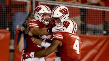MADISON, WI - AUGUST 31: Garrett Groshek #37, Alex Hornibrook #12, and A.J. Taylor #4 of the Wisconsin Badgers celebrate after scoring a touchdown in the fourth quarter against the Western Kentucky Hilltoppers at Camp Randall Stadium on August 31, 2018 in Madison, Wisconsin. (Photo by Dylan Buell/Getty Images)