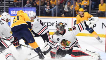 Chicago Blackhawks goaltender Kevin Lankinen (32) defends a shot attempt by Nashville Predators center Nick Cousins (21) during the first period at Bridgestone Arena. Mandatory Credit: Christopher Hanewinckel-USA TODAY Sports