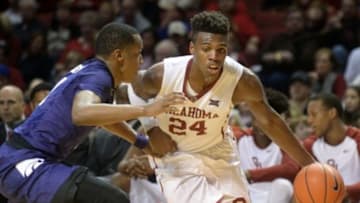 Jan 9, 2016; Norman, OK, USA; Oklahoma Sooners guard Buddy Hield (24) drives to the basket in front of Kansas State Wildcats guard Barry Brown (5) during the second half at Lloyd Noble Center. Mandatory Credit: Mark D. Smith-USA TODAY Sports