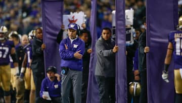 SEATTLE, WA - NOVEMBER 19: Head coach Chris Petersen of the Washington Huskies looks on as assistants behind him hold cloth partitions shielding play signals against the Arizona State Sun Devils on November 19, 2016 at Husky Stadium in Seattle, Washington. The Huskies defeated the Sun Devils 44-18. (Photo by Otto Greule Jr/Getty Images)