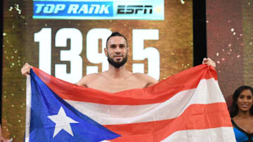 Boxer Jose Pedraza poses with a Puerto Rican flag. (Photo by Ethan Miller/Getty Images)
