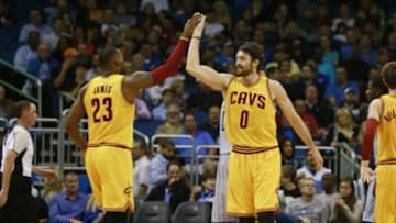 Dec 11, 2015; Orlando, FL, USA; Cleveland Cavaliers forward Kevin Love (0) high fives forward LeBron James (23) against the Orlando Magic during the second half at Amway Center. The Cavaliers won 111-76. Mandatory Credit: Kim Klement-USA TODAY Sports