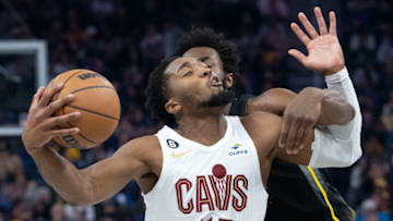 November 11, 2022; San Francisco, California, USA; Cleveland Cavaliers guard Donovan Mitchell (45) is fouled by Golden State Warriors forward Andrew Wiggins (22) during the second quarter at Chase Center. Mandatory Credit: Kyle Terada-USA TODAY Sports