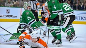 Apr 6, 2023; Dallas, Texas, USA; Philadelphia Flyers right wing Travis Konecny (11) is tripped up in front of Dallas Stars goaltender Jake Oettinger (29) during the third period at the American Airlines Center. Mandatory Credit: Jerome Miron-USA TODAY Sports