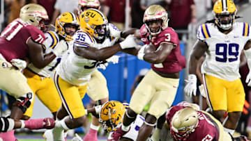 ORLANDO, FLORIDA - SEPTEMBER 03: Trey Benson #3 of the Florida State Seminoles breaks a tackle from Sai'vion Jones #35 of the LSU Tigers in the first quarter at Camping World Stadium on September 03, 2023 in Orlando, Florida. (Photo by Julio Aguilar/Getty Images)