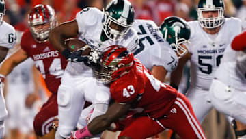 BLOOMINGTON, IN - OCTOBER 1: LJ Scott #3 of the Michigan State Spartans runs the ball as Dameon Willis Jr. #43 of the Indiana Hoosiers makes the tackle at Memorial Stadium on October 1, 2016 in Bloomington, Indiana. Indiana defeated Michigan State 24-21. (Photo by Michael Hickey/Getty Images)