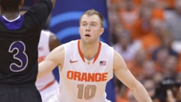 Nov 28, 2014; Syracuse, NY, USA; Syracuse Orange guard Trevor Cooney (10) plays defense against a Holy Cross Crusaders player during the second half of a game at the Carrier Dome. Syracuse won the game 72-48. Mandatory Credit: Mark Konezny-USA TODAY Sports