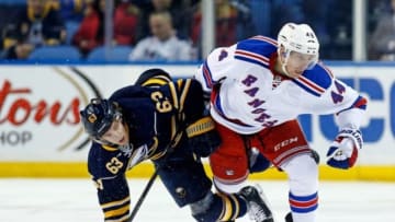 Mar 14, 2015; Buffalo, NY, USA; Buffalo Sabres left wing Tyler Ennis (63) and New York Rangers defenseman Matt Hunwick (44) collide at mid ice during the first period at First Niagara Center. Mandatory Credit: Kevin Hoffman-USA TODAY Sports