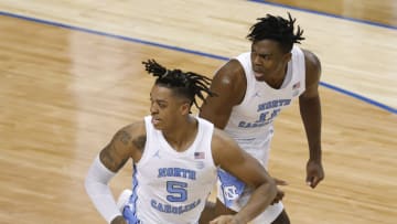GREENSBORO, NORTH CAROLINA - MARCH 10: Armando Bacot #5 and Day'Ron Sharpe #11 of the North Carolina Tar Heels react following a basket during the second half of their second round game against the Notre Dame Fighting Irish in the ACC Men's Basketball Tournament at Greensboro Coliseum on March 10, 2021 in Greensboro, North Carolina. (Photo by Jared C. Tilton/Getty Images)