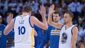 January 5, 2015; Oakland, CA, USA; Golden State Warriors guard Stephen Curry (30) celebrates with forward David Lee (10) during the third quarter against the Oklahoma City Thunder at Oracle Arena. The Warriors defeated the Thunder 117-91. Mandatory Credit: Kyle Terada-USA TODAY Sports