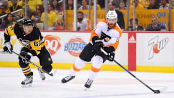 PITTSBURGH, PA - APRIL 20: Philadelphia Flyers center Sean Couturier (14) passes the puck during the third period. The Philadelphia Flyers avoided elimination with a 4-2 win in Game Five of the Eastern Conference First Round during the 2018 NHL Stanley Cup Playoffs against the Pittsburgh Penguins on April 20, 2018, at PPG Paints Arena in Pittsburgh, PA. The Penguins lead the series 3-2. (Photo by Jeanine Leech/Icon Sportswire via Getty Images)