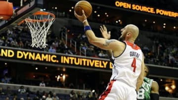 Jan 22, 2014; Washington, DC, USA; Washington Wizards center Marcin Gortat (4) shoots as Boston Celtics small forward Jeff Green (8) defends during the first half at Verizon Center. Mandatory Credit: Brad Mills-USA TODAY Sports