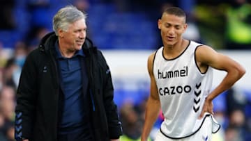 Everton's Italian head coach Carlo Ancelotti (L) jokes with Everton's Brazilian striker Richarlison after the English Premier League football match between Everton and Wolverhampton Wanderers at Goodison Park in Liverpool, north west England on May 19, 2021. - RESTRICTED TO EDITORIAL USE. No use with unauthorized audio, video, data, fixture lists, club/league logos or 'live' services. Online in-match use limited to 120 images. An additional 40 images may be used in extra time. No video emulation. Social media in-match use limited to 120 images. An additional 40 images may be used in extra time. No use in betting publications, games or single club/league/player publications. (Photo by Jon Super / POOL / AFP) / RESTRICTED TO EDITORIAL USE. No use with unauthorized audio, video, data, fixture lists, club/league logos or 'live' services. Online in-match use limited to 120 images. An additional 40 images may be used in extra time. No video emulation. Social media in-match use limited to 120 images. An additional 40 images may be used in extra time. No use in betting publications, games or single club/league/player publications. / RESTRICTED TO EDITORIAL USE. No use with unauthorized audio, video, data, fixture lists, club/league logos or 'live' services. Online in-match use limited to 120 images. An additional 40 images may be used in extra time. No video emulation. Social media in-match use limited to 120 images. An additional 40 images may be used in extra time. No use in betting publications, games or single club/league/player publications. (Photo by JON SUPER/POOL/AFP via Getty Images)
