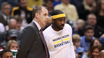 Mar 24, 2016; Indianapolis, IN, USA; Indiana Pacers coach Frank Vogel (L) talks to guard Ty Lawson (10) on the sidelines against the New Orleans Pelicans at Bankers Life Fieldhouse. Mandatory Credit: Brian Spurlock-USA TODAY Sports
