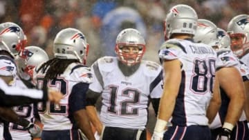Nov 29, 2015; Denver, CO, USA; New England Patriots quarterback Tom Brady (12) talks with teammates in the huddle during the second half against the Denver Broncos at Sports Authority Field at Mile High. The Broncos won 30-24. Mandatory Credit: Chris Humphreys-USA TODAY Sports