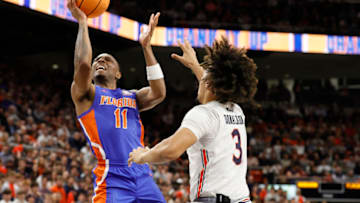 Dec 28, 2022; Auburn, Alabama, USA; Florida Gators guard Kyle Lofton (11) gets past Auburn Tigers guard Tre Donaldson (3) for a shot during the first half at Neville Arena. Mandatory Credit: John Reed-USA TODAY Sports