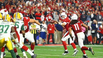 Jan 16, 2016; Glendale, AZ, USA; Arizona Cardinals quarterback Carson Palmer (3) throws a shovel pass to wide receiver Larry Fitzgerald (11) to score a touchdown in overtime against the Green Bay Packers during an NFC Divisional round playoff game at University of Phoenix Stadium. Mandatory Credit: Mark J. Rebilas-USA TODAY Sports