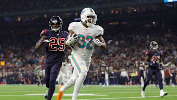 HOUSTON, TX - OCTOBER 25: Kenyan Drake #32 of the Miami Dolphins catches a pass and scores a touchdown defended by Kareem Jackson #25 of the Houston Texans in the third quarter at NRG Stadium on October 25, 2018 in Houston, Texas. (Photo by Tim Warner/Getty Images)