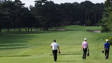 Golfers walk down the first hole fairway during the Japan junior golf championships, a test event ahead of the Tokyo 2020 Olympic Games at the Kasumigaseki country club in Kawagoe on August 14, 2019. (Photo by TOSHIFUMI KITAMURA / AFP) (Photo credit should read TOSHIFUMI KITAMURA/AFP via Getty Images)
