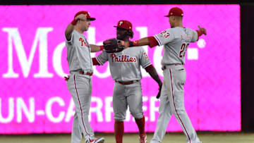 MIAMI, FL - MAY 2: Rhys Hoskins #17 of the Philadelphia Phillies hugs Odubel Herrera #37 and Aaron Altherr #23 after defeating the Miami Marlins at Marlins Park on May 2, 2018 in Miami, Florida. (Photo by Eric Espada/Getty Images)