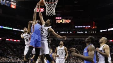Jan 22, 2014; San Antonio, TX, USA; Oklahoma City Thunder forward Kevin Durant (35) gets fouled while shooting agains San Antonio Spurs forward Tim Duncan (21) during the second half at AT&T Center. The Thunder won 111-105. Mandatory Credit: Soobum Im-USA TODAY Sports